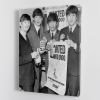 The Beatles with an Oxfam poster Canvas Print or Poster